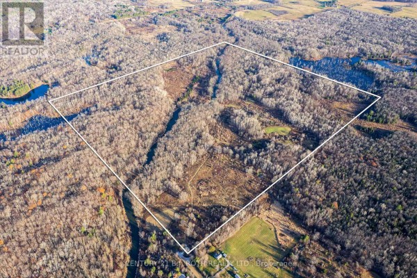 Expansive aerial view showing a river flowing through a vast wooded area with some snow patches. - 1007 Mount Stephen Road Ne, Severn