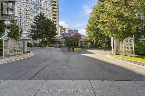 Driveway leading to the main entrance of a large apartment building with a covered canopy. - 1009 - 1320 Islington Avenue, Toronto