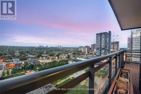 View from balcony overlooking city neighborhood and parkland at sunset. - 1009 - 225 Sackville Street, Toronto