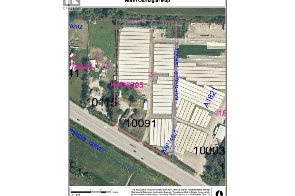 Aerial view of a residential house with a greenhouse and agricultural fields in the background. - 10091 6 Highway, Coldstream