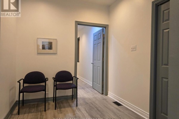 Narrow corridor with track lighting and frosted glass partitions - 100a - 253 Danforth Avenue, Toronto