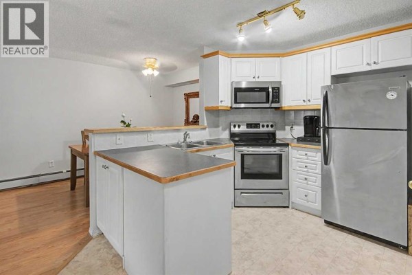 Living room - 101, 7724 Bowness Road Nw, Calgary, AB T3B0H1 Photo 5