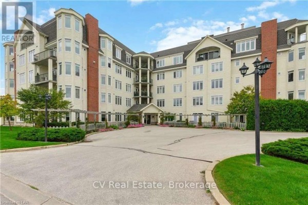 Front exterior of a multi-story apartment building with a central entrance and surrounding parking lot. - 101 - 10 Bay Street, Blue Mountains