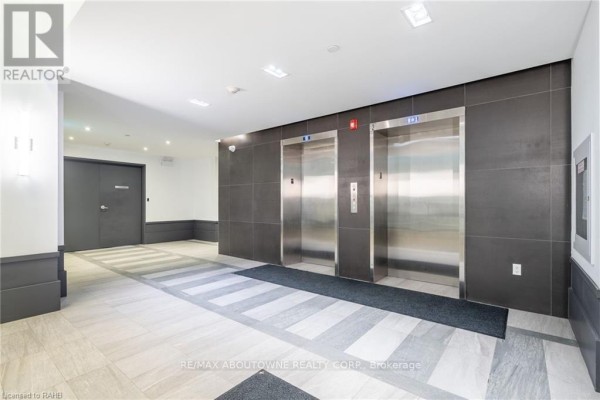 Elevator lobby with brushed metal elevator doors and tiled flooring. - 101 - 10 Concord Place, Grimsby