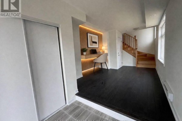 Bedroom with grey carpet and a large window overlooking the street. - 101 - 1865 Pickering Parkway S, Pickering