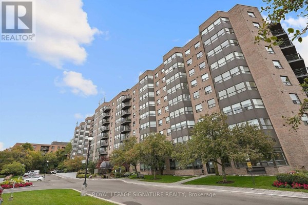 Low angle exterior view of a tall brick apartment building with many windows and balconies. - 101 - 2 Raymerville Drive, Markham