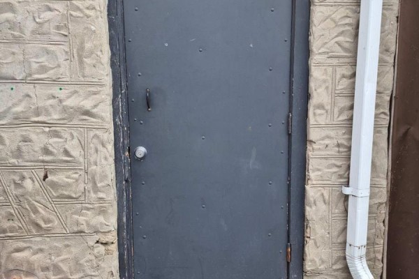 Exterior grey metal door with decorative concrete block siding. - 101 - 624 King Street E, Cambridge