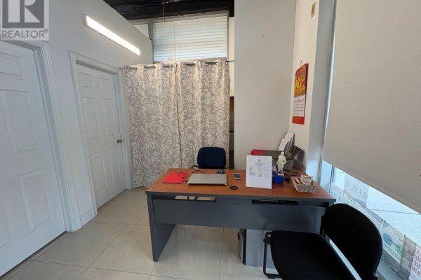 Treatment room featuring a massage table, sink, and seating area - 101 - 7130 Warden Avenue, Markham