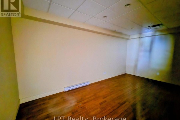 Small office space with built-in cabinetry and gray carpet - 101 - 74 Simcoe Street S, Oshawa