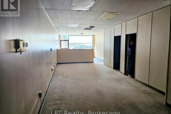 Reception area view from the opposite side with wooden counter - 101 - 74 Simcoe Street S, Oshawa