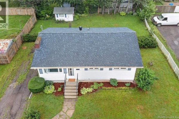 Aerial view showing the roof of the bungalow and its spacious, green backyard. - 101 Birchmount Drive, Moncton