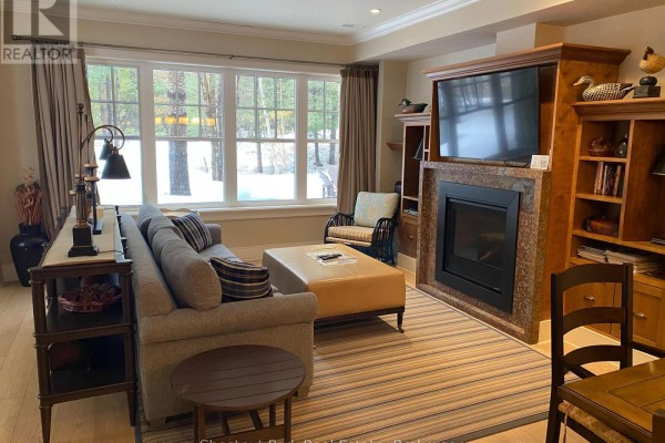 Cozy seating area with large windows overlooking snowy landscape. - 101 Emerald Hill Court S, Seguin