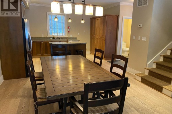 Seating area with striped rug, large windows, and views of the outdoors. - 101 Emerald Hill Court S, Seguin