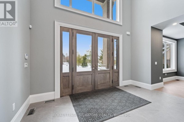Empty room with dark gray walls, a coffered ceiling with recessed lighting, and light wood floors. - 101 Perryman Court, Erin