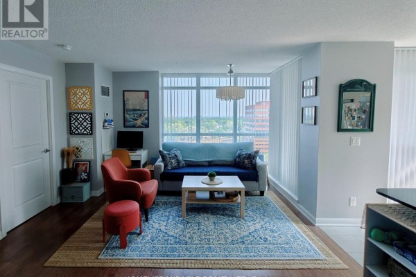 Living area with floor-to-ceiling windows, light grey walls, and hardwood floors. - 1010 - 205 Sherway Gardens Road, Toronto