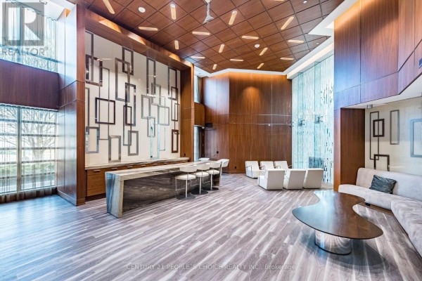 Amenity space with marble bar, stools, lounge seating, and wood-paneled walls. - 1012 - 205 Sherway Garden, Toronto
