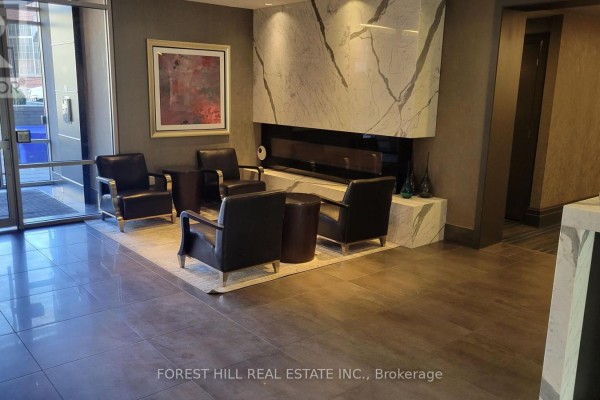 Lobby seating area with black leather chairs and a modern fireplace. - 1012 - 60 Berwick Avenue, Toronto