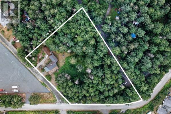 Aerial view of a large treed lot with a house in the center. - 1012 Fairdowne Rd, Errington