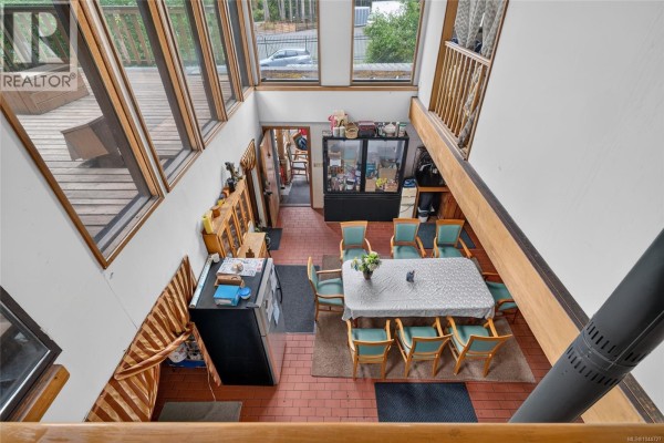 View from above of a dining area with a table, chairs, and stairs. - 1012 Fairdowne Rd, Errington