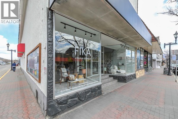 Corner view of a storefront with large display windows showcasing merchandise and interior lighting. - 10122/24 Main Street, Summerland
