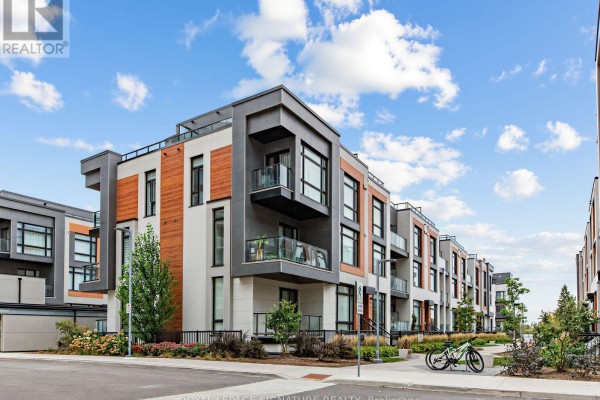 Exterior view of a multi-story townhouse building with balconies and a bicycle parked nearby. - 1014 - 14 David Eyer Road, Richmond Hill