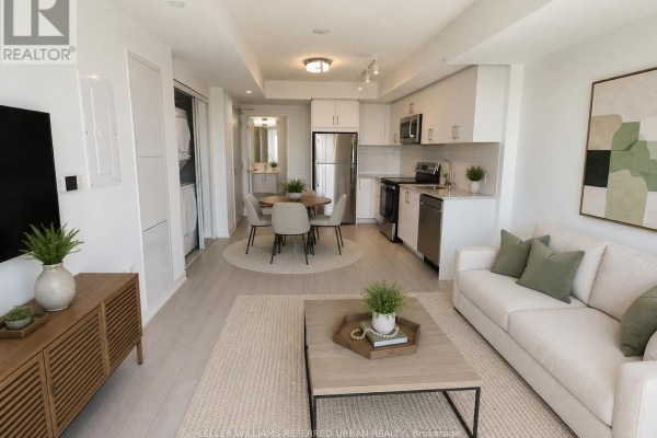 Kitchen with stainless steel refrigerator, microwave, stove, dishwasher, white cabinets, and granite countertops. - 1014 - 4010 Eglinton Avenue W, Toronto