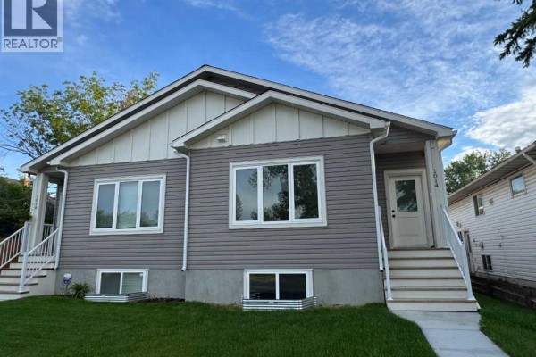 Close-up of entrance with steps and landscaped yard - 1014 Limit Avenue, Crossfield
