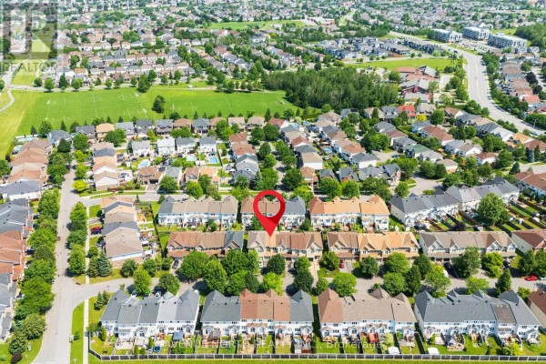 Aerial view of the residential neighborhood with the subject townhouse highlighted. - 1015 Candlewood Street, Ottawa