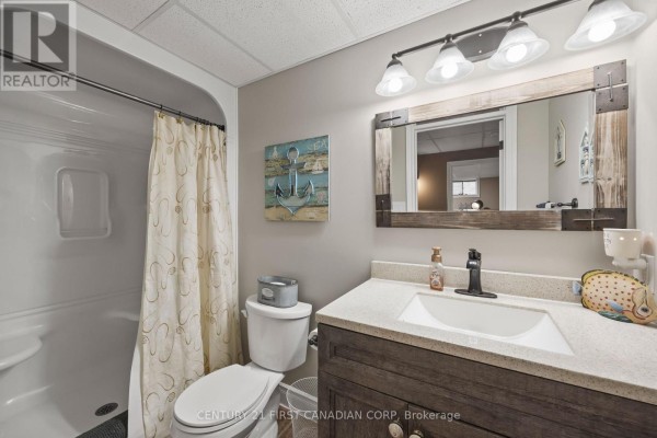 Bathroom with walk-in shower, vanity, ship-lap mirror, anchor art - 10159 Meadowlilly Crescent Lambton Shores