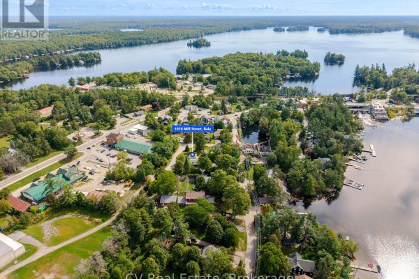 Aerial view of Bala village, showing roads, buildings, and waterfront properties along the lake. - 1016 Mill Street, Muskoka Lakes