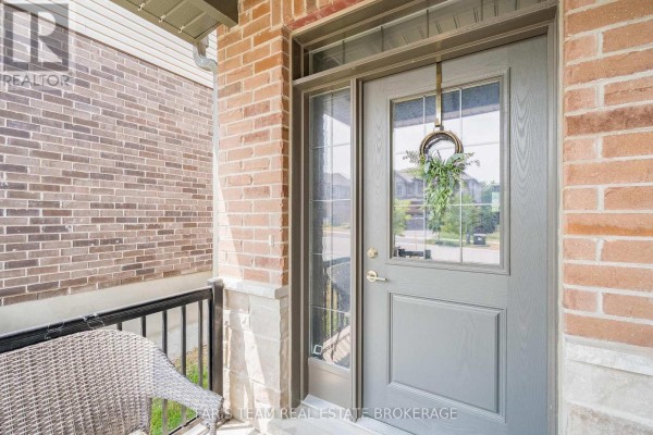 Modern kitchen with white cabinets, stainless steel appliances, and a black granite island with seating. - 1016 Wright Drive, Midland