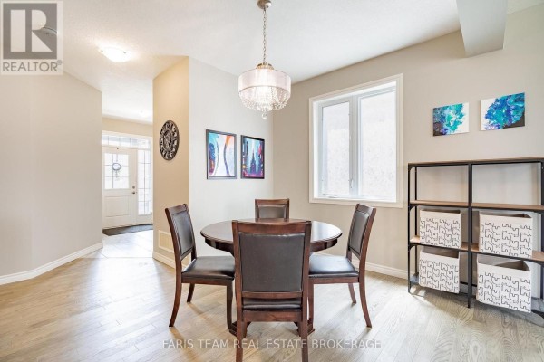 Dining room with round table, chairs, and chandelier - 1016 Wright Drive Midland