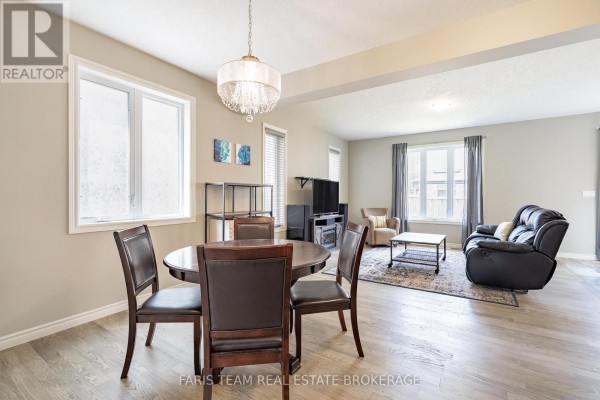 Dining area with round table and living room with black leather sofa - 1016 Wright Drive Midland