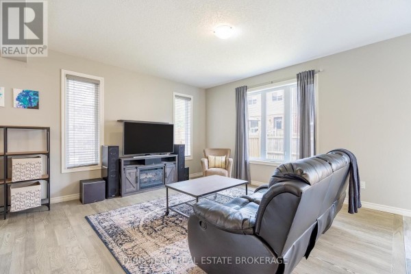 Living room with electric fireplace, leather sofa, and TV - 1016 Wright Drive Midland
