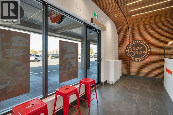 Interior view of Pizza Pizza with counter, beverage coolers, and menu. - 1019 Shoppers Row, Campbell River