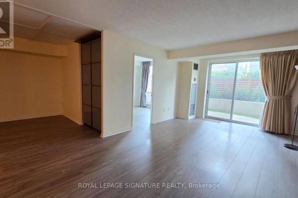Long building hallway with patterned carpet and several elevator doors. - 102 - 101 Subway Crescent, Toronto
