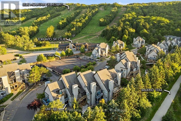 Aerial view of townhouses with Unit 102 labeled, near ski hills, tennis courts, and walking trails. - 102 - 796468 Grey Road 19 Road, Blue Mountains