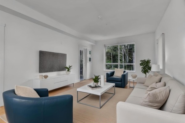 Modern kitchen with dark cabinetry, stainless steel appliances, and a central island with seating. - 102 3480 146a Street, Surrey