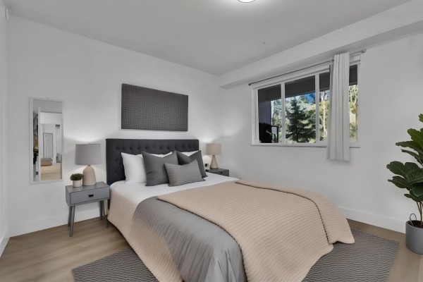 Bathroom with a modern vanity, large mirror, and minimalistic decor. - 102 3480 146a Street, Surrey
