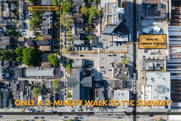 Bedroom with a king-size bed, a long wall of white built-in closets, and dark hardwood floors. - 102 Gough Avenue, Toronto