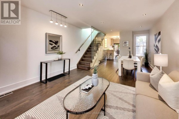 Contemporary bathroom with a floating vanity, modern sink, large mirror, and a glass-enclosed shower. - 102 Gough Avenue, Toronto