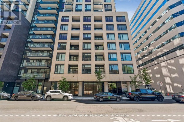 Close-up exterior view of a modern apartment building with multiple windows and balconies. - 1021 - 543 Richmond Street W, Toronto