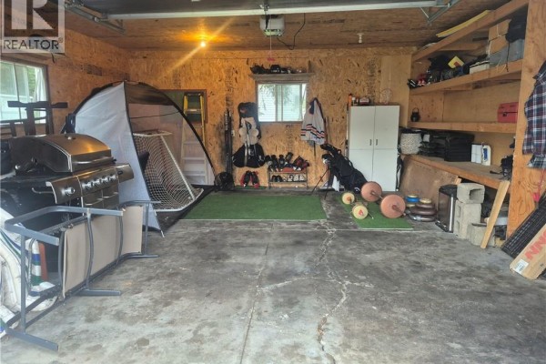 Outdoor patio area with light brown wooden fence, pergola, and patio furniture. - 1024 Rue Misho, Beresford