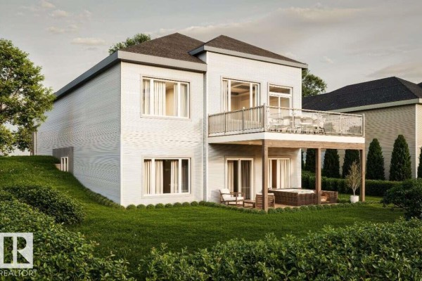 Rear view of a modern house with a balcony, patio, and hot tub. - 10252 92a, Morinville