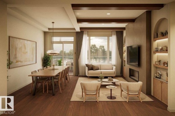 Living room with a sofa, coffee table, fireplace, and dining area with a view of a lake. - 10252 92a, Morinville