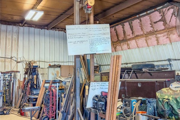 Utility truck parked in workshop with various tools and materials around - 103 - 105 1st Avenue W, Climax