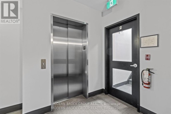 Elevator area with stainless steel doors and fire safety equipment - 103 - 1109 Millwood Avenue, Brockville