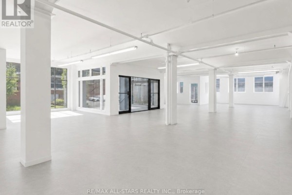 Aerial view of a multi-story commercial building with a flat roof. - 103 - 14 Mccaul Street, Toronto