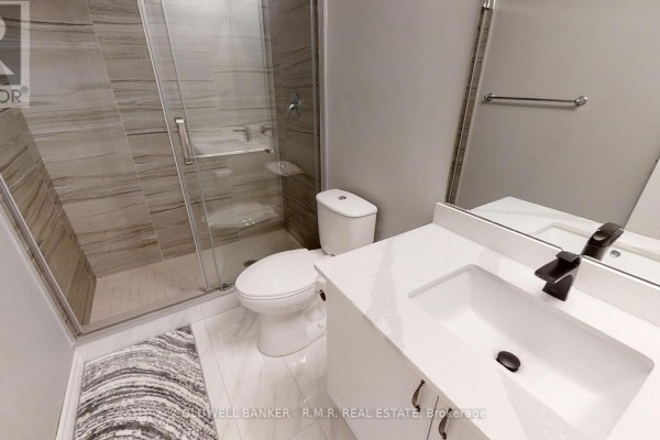 Bathroom with a glass-enclosed shower, white vanity, and light grey tiled walls. - 103 - 157 Wellington Street E, New Tecumseth