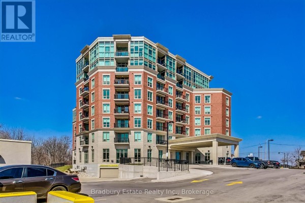Exterior of a brick and light-colored siding apartment building with a covered entrance and blue sky. - 103 - 2750 King Street E, Hamilton
